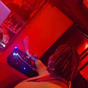 a woman playing a dj at a nightclub