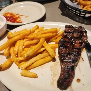 a steak and fries on a plate