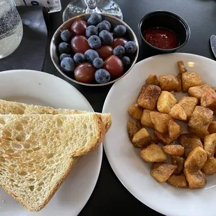 My side-order meal: sourdough toast, well-done home-fried potatoes &amp; fresh fruit.