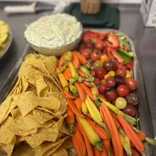 Spinach and artichoke platter with tricolored carrots, fresh veggies and tortilla chips.