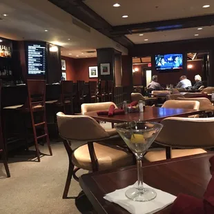 a glass of martini on a table