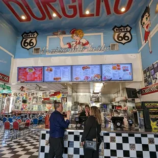 two people standing in front of the counter