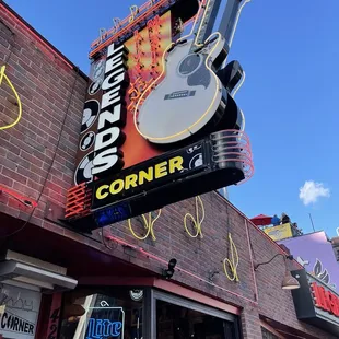 a neon sign for a guitar shop