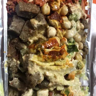 Legends Halal   Combo over rice - spicy white sauce, cilantro sauce, and hot sauce; chickpeas and hummus; extra protein!!!