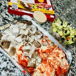 Lamb and Chicken over rice with white sauce, Salad on the side.