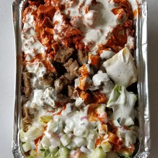 Combo platter over rice with hot and white sauce.