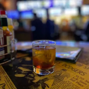 a glass of whiskey on a table