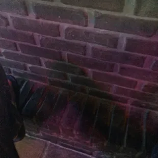 a brick wall with a hole in it