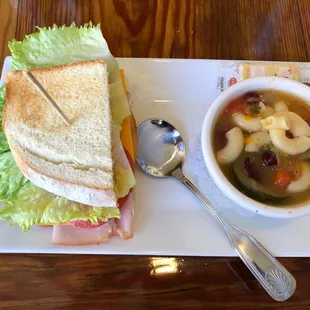 Half a Turkey sandwich on white with minestrone soup.