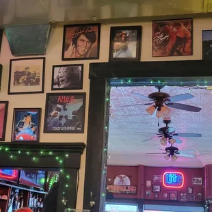 a ceiling fan and a neon sign