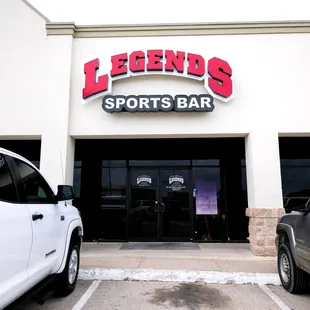 two trucks parked in front of the building