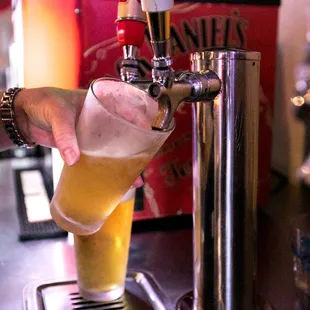a person pouring a beer