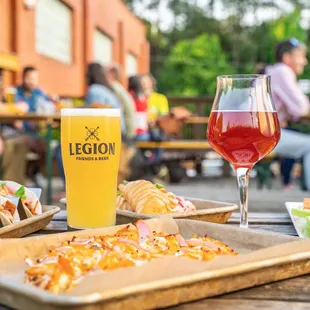 a table with food and a glass of beer