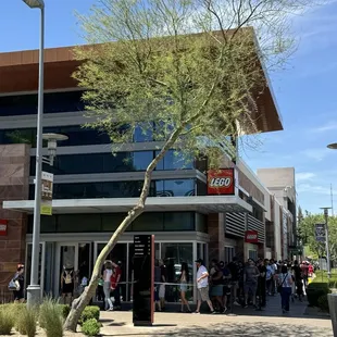 Exterior with line of people around the corner