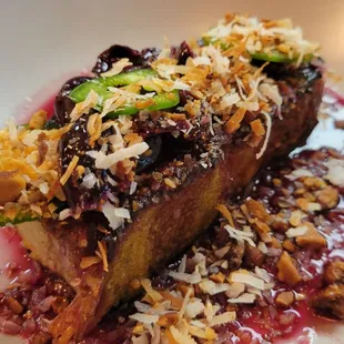 Pork belly starter with jalapeño, cherry, compote coconut and peanuts