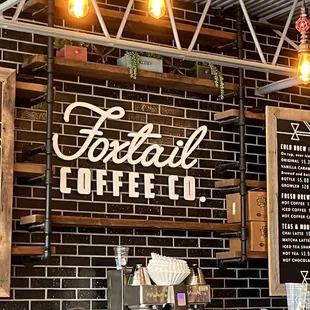 a coffee shop with a menu on the wall