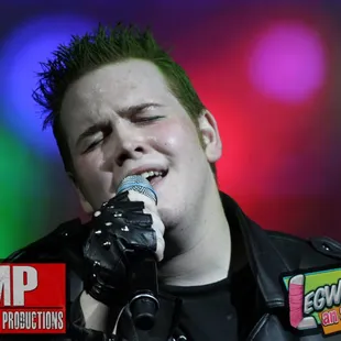 a man singing into a microphone