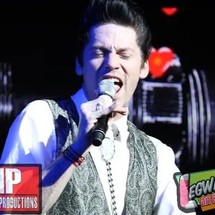 a man singing into a microphone