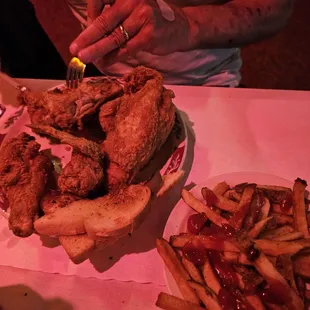 a plate of fried chicken and french fries