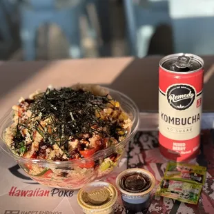 a bowl of food and a can of kombucha