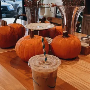 a cup of iced coffee and pumpkins
