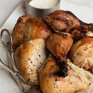 a plate of chicken with a side of sauce and a pair of scissors