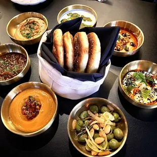 The Seven Salads (Olives, Zaalouk, Muhammara, Lebni, Bissara, Tomato Jam, Cucumber) with Za'atar Flatbread