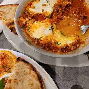I wish I knew how to spell this, shaksouka? Soft cooked eggs in a tomato base veggie skillet.