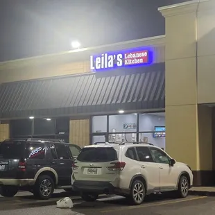 cars parked in front of a restaurant