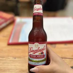 a hand holding a bottle