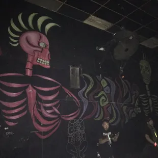 a wall with a skeleton painted on it