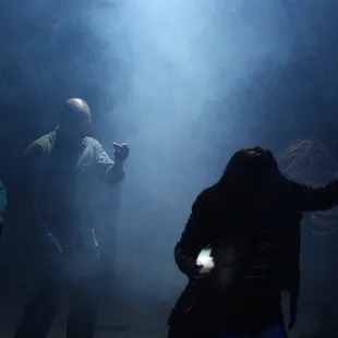 a group of people dancing in the dark