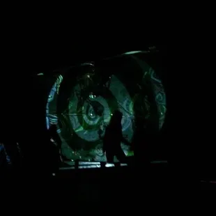 a man standing in front of a large screen