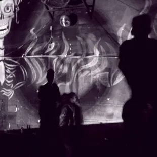 a man standing in front of a mural