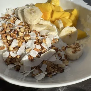 Homemade granola parfait. Tropical with coconuts and mango