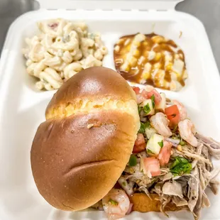 a pulled pork sandwich and macaroni salad