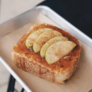 a piece of toast with apples on it
