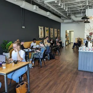 people sitting at tables in a coffee shop