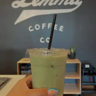 a hand holding a cup of coffee