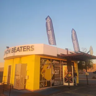 a yellow building with banners on it