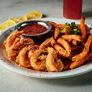 a plate of fried shrimp and fries