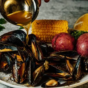 a plate of mussels and corn