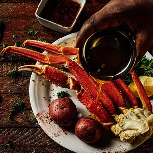 crab legs and potatoes on a plate