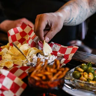 a person cutting up a plate of food