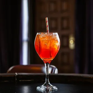 a drink in a wine glass on a table