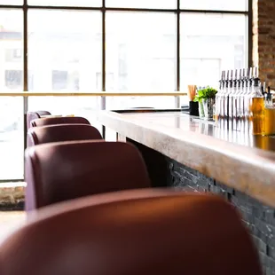 a row of leather chairs at a bar