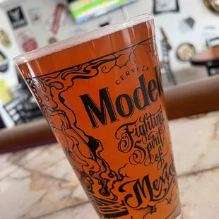 a pint glass with the word model on it