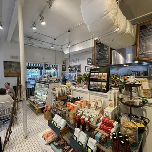 the inside of a store with people sitting at tables