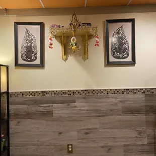 a wall with three framed pictures