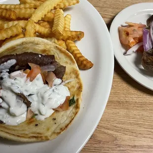 Gyro sandwich, so stuffed with meat it can make two sandwiches